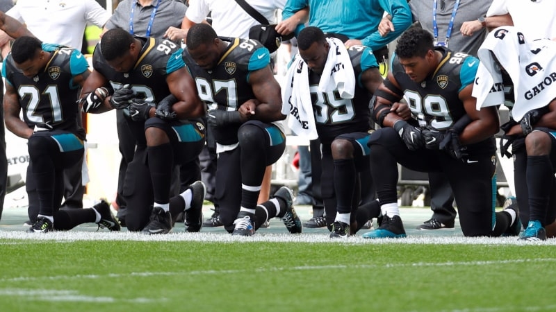 NFL players, coaches, owners lock arms, kneel during national anthem