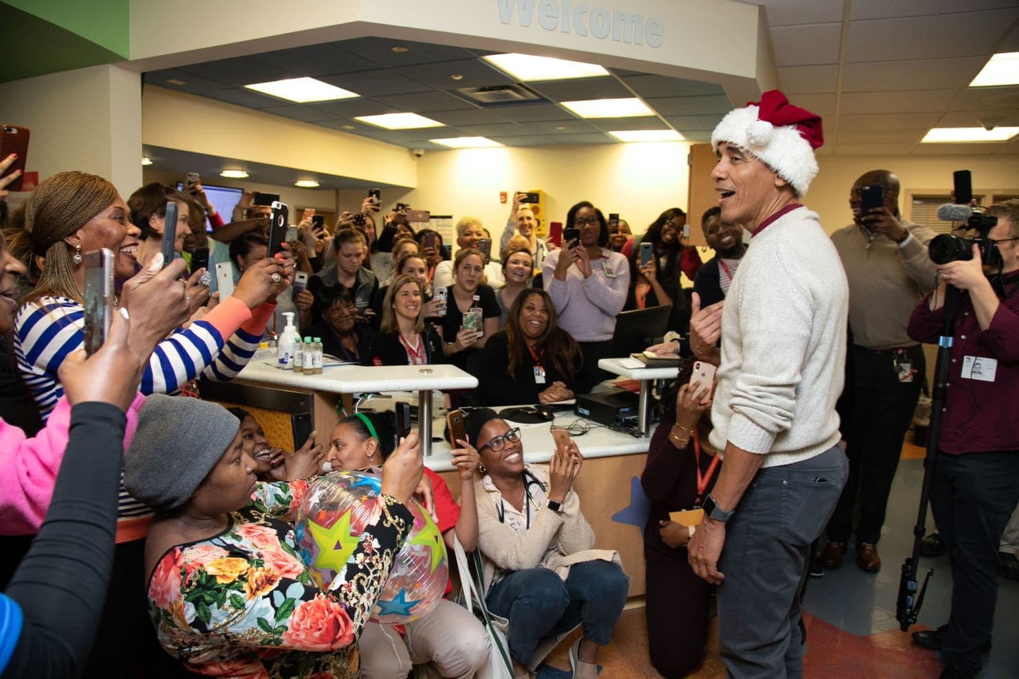 Barack Obama dons a Santa hat and hands out gifts in surprise visit to children’s hospital