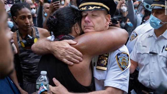Police officers are joining protesters for prayers and hugs in several US cities