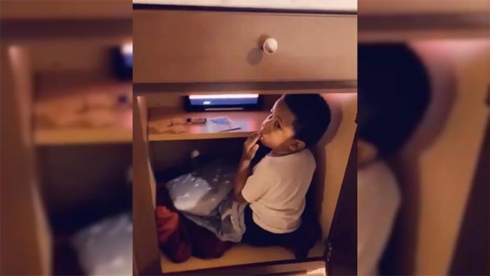 Toddler busted after creating secret hiding space in cabinet to watch cartoons, eat crackers